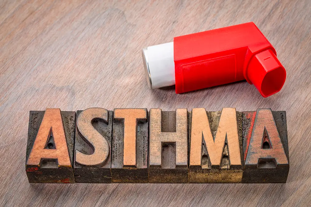 Block letters spelling Asthma with an inhaler above