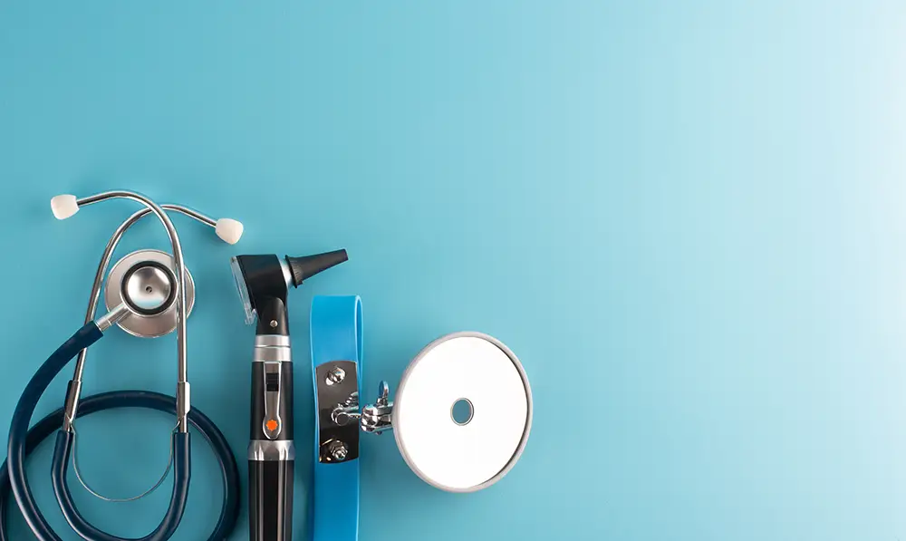 Medical instruments for ENT doctors set against a blue background