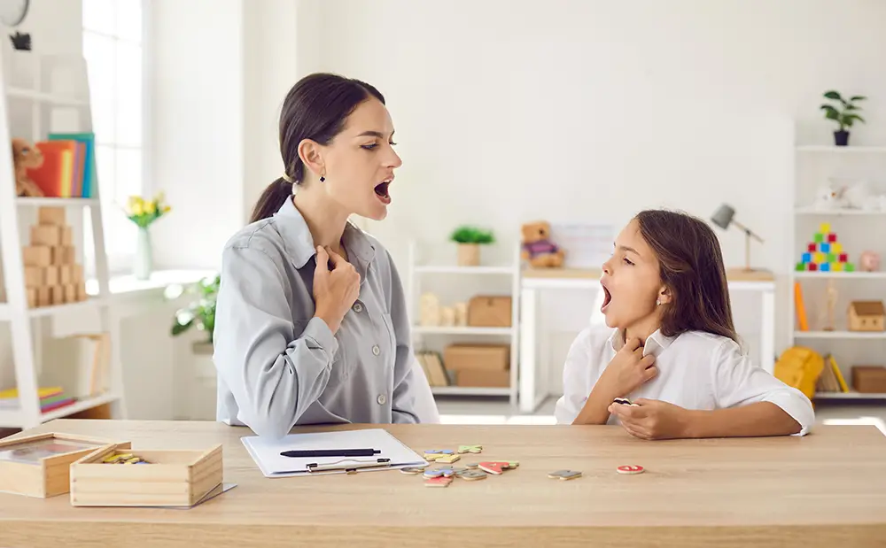 A speech therapist doing vocal exercises with a student
